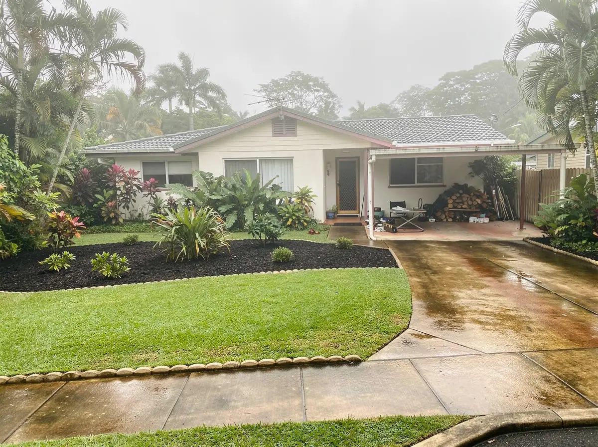 After: front yard with fresh lawn, mulched gardens and tidy carport